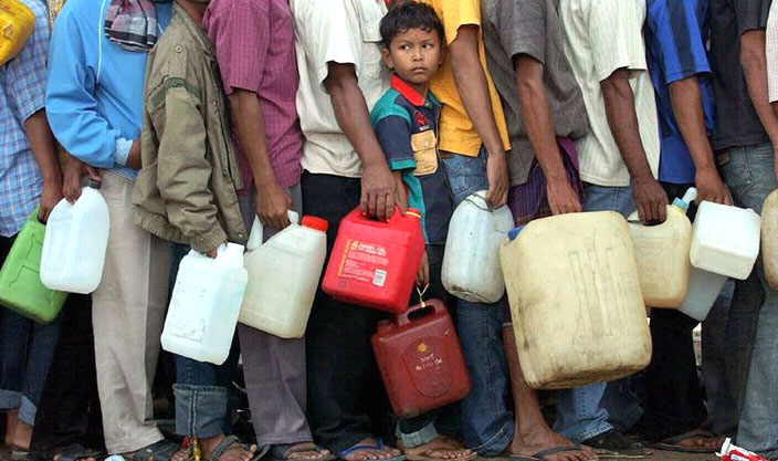 Survivors of the tsunami in Banda Aceh wait in line for gasoline.  Some have waited for three days.  Image Credit: MSNBC.com