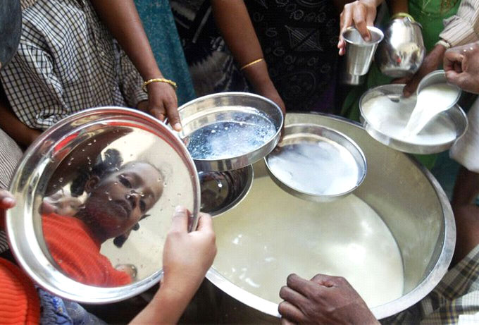 People wait in line for milk to feed themselves and their families.  Image credit: MSNBC.com