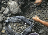 Residents dig in rubble, scavenging for coins buried by tsunami.  Image credit: MSNBC.com