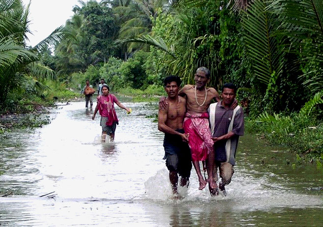 Residents of a village in Sumatra flee from their homes.  Image credit: Getty Images
