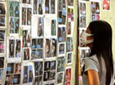 Survivor looks at wall of missing persons.  Image credit: MSNBC.com