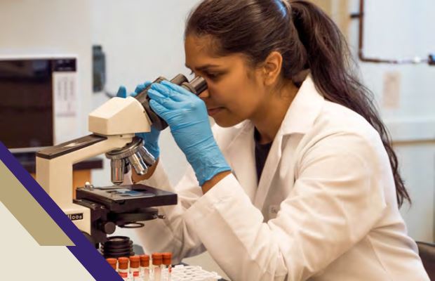 A woman using a microscope